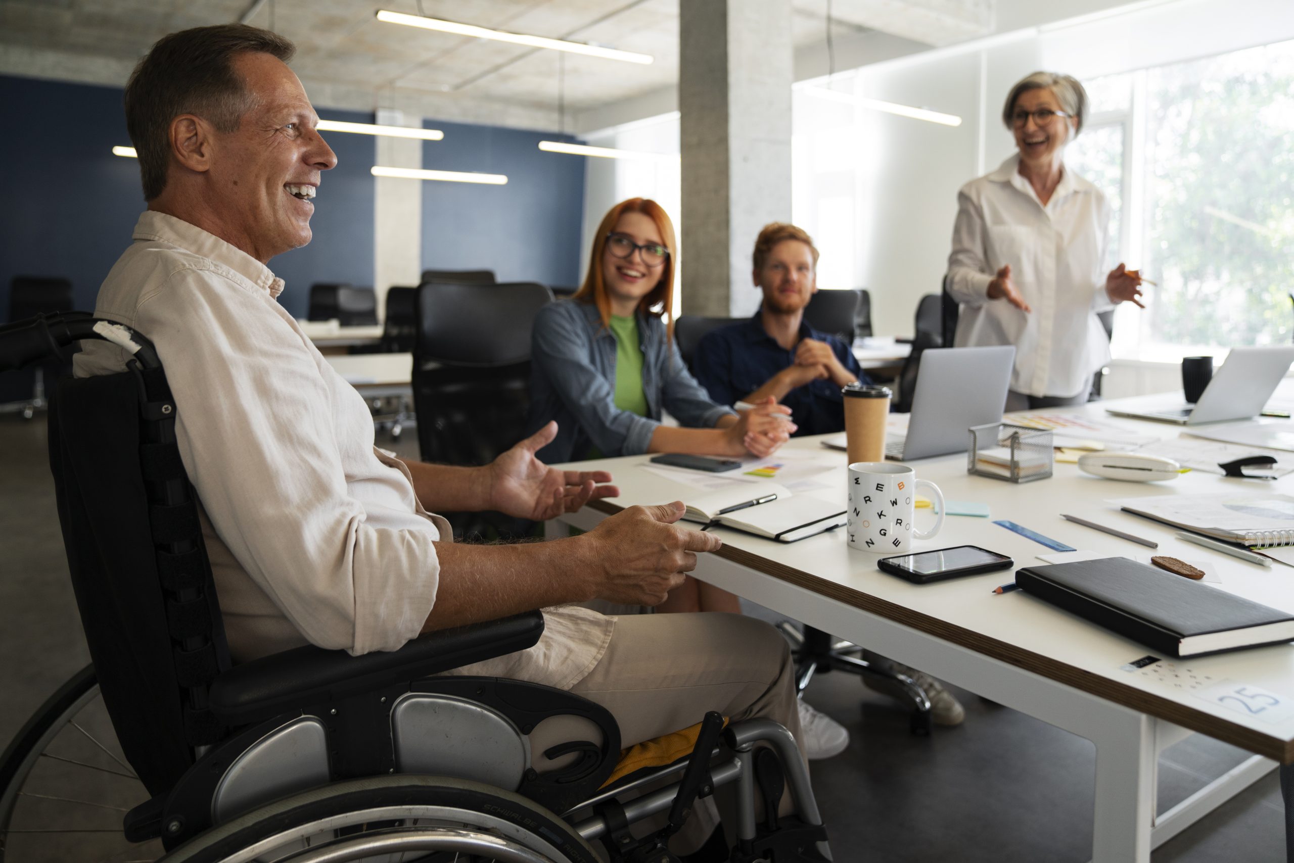Man wheelchair having inclusive office job